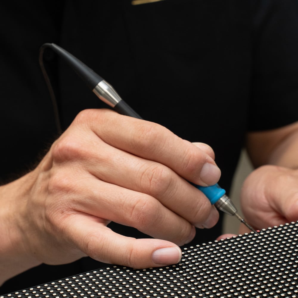 A technician conducts a pixel repair as part of an LED sign repair.